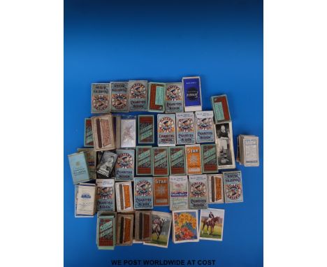 A collection of cigarette cards in packets, some full sets, including loose Ogdens film stars etc, an album of WWI era postca