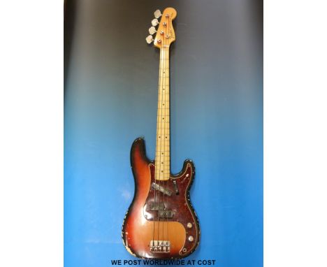 A late 1960's Fender Precision bass guitar in sunburst finish, made in the USA, serial no 261928 in soft case and with origin