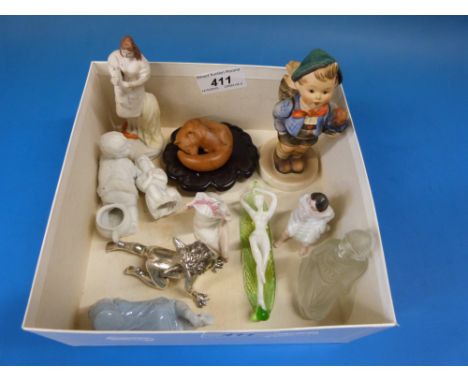 A collection of bisque and glass small figures, a well-cast plated cherub and a Goebel Hummel